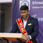 A student speaking on stage with confidence