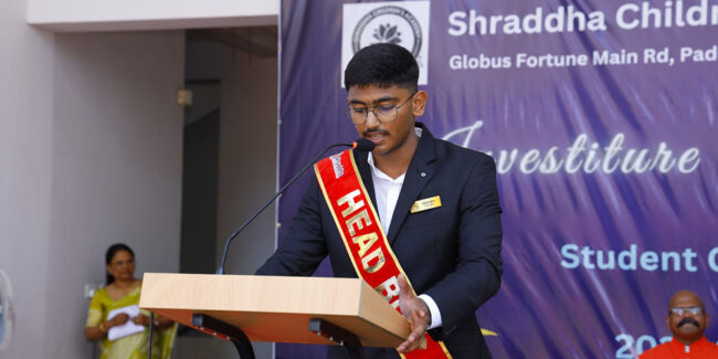 A student speaking on stage with confidence A student speaking on stage with confidence